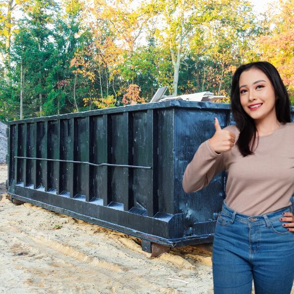 Image showing a satisfied customer after using a rolloff dumpster for waste disposal.